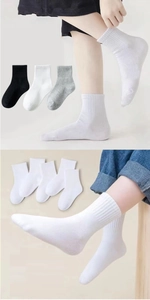 Detail of soft ribbed cuffs and breathable cotton fabric on multi-color crew socks