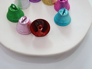 Macro shot of 26mm frosted glitter metal Christmas bells in various festive colors