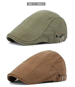 Detail of herringbone cotton flat caps with silver side buckles in green and brown