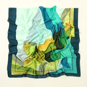 Detail of silk satin scarf featuring geometric prints and smooth glossy texture folds
