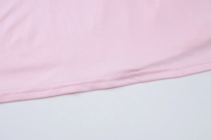 Dettaglio dell'orlo del vestito rosa con doppia cucitura professionale e trama del tessuto