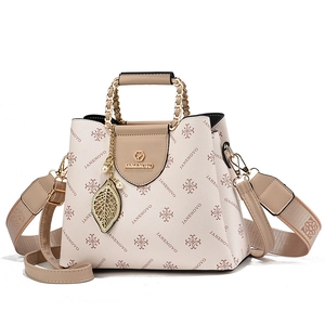Contrast color monogram shoulder bag with leaf pendant and wide fabric strap in beige