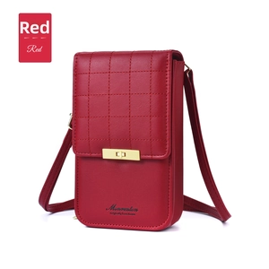 Detail of red quilted faux leather crossbody phone bag with gold metal twist lock closure