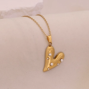 Golden melted heart pendant necklace with faux pearls on a delicate gold chain