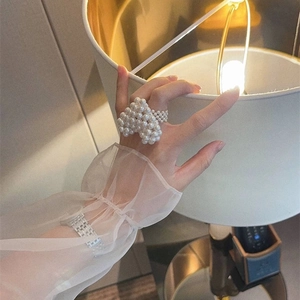 Handmade oversized pearl heart ring featuring a cute bow and woven beaded design