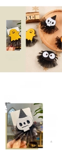 Detail of Halloween hair clips featuring ghost, skull and spider designs with black mesh