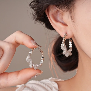 Silver geometric twisted mesh hoop earrings with minimalist metallic braided texture