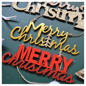 Detail of wooden Merry Christmas hanging ornaments with glitter finish and hemp rope hooks