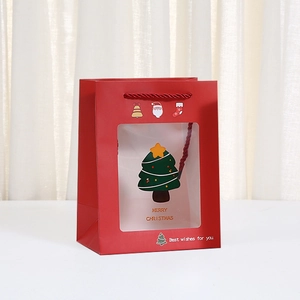 Red Christmas paper gift bag with window and festive Santa and tree patterns