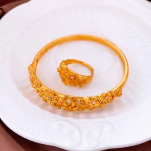 Vintage gold plated floral jewelry set with ring and bracelet featuring inlaid crystals