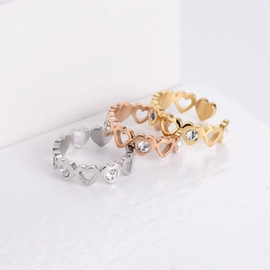 Three heart-shaped adjustable rings set in silver rose gold and gold finishes with zircons