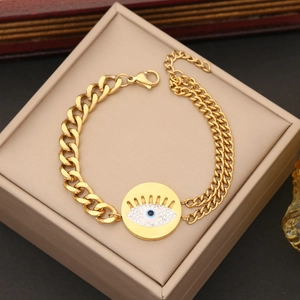 Gold evil eye bracelet with cuban links and crystals on a jewelry gift box
