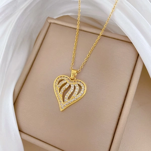 Detail of a hollow heart pendant with wavy lines and sparkling diamonds on a silk background