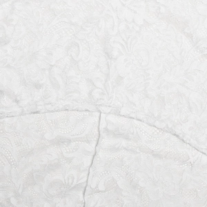 Close-up of white floral lace fabric with intricate mesh patterns on a slim dress