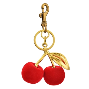 Plush red cherry keychain with golden leaf and spring clip on white background