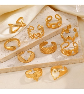 Detail of 10-piece gold-plated heart and butterfly rings on elegant stone display