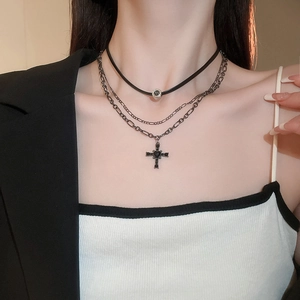 Dettaglio della collana punk a più strati con ciondoli a croce neri e perline di strass