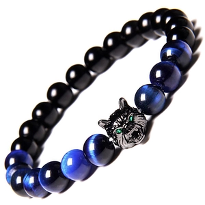Macro detail of men's beaded bracelet featuring a wolf head and blue tiger eye stones