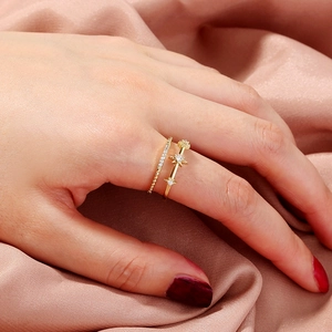 Golden rings set featuring a sparkling diamond band and a vintage star-shaped open ring