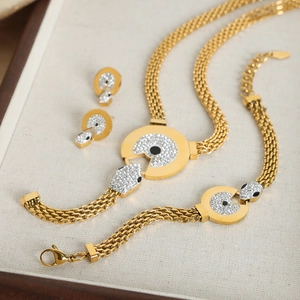 Luxury gold titanium steel jewelry set with pavé diamonds and woven strap design