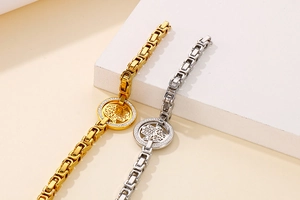Macro view of gold and silver Hamsa hand bracelets with cubic zirconia and square links