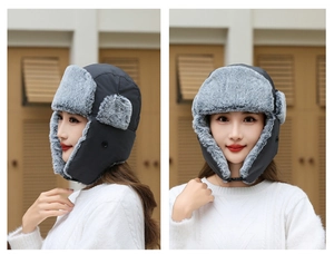 Detail of dark grey windproof trapper hat with warm faux fur lining and ear flaps