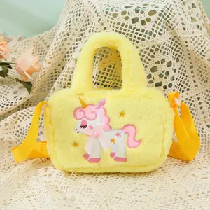 Detail of plush yellow unicorn crossbody bag featuring soft fur and bow embroidery