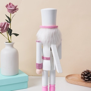 Rear view of pink wooden nutcracker soldier showing lever and glitter details