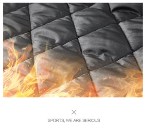 Detailed close-up of black diamond-quilted thermal fabric with heat retention visual effect