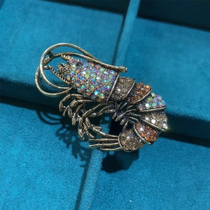 Vintage lobster brooch with colorful rhinestones in a luxury blue velvet jewelry box