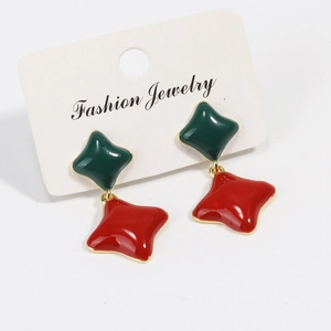 Detail view of retro clover earrings with green and red enamel and gold-plated star charms