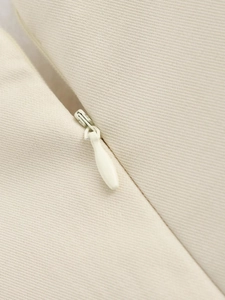 Close-up of the hidden zipper and durable twill fabric on a beige cushion cover