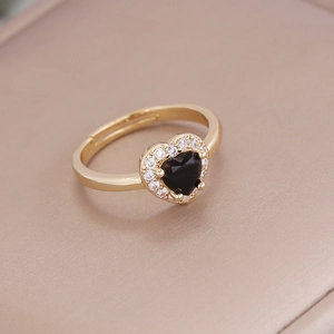 Macro detail of 18K gold ring with black heart zircon and sparkling micro-inlaid diamonds