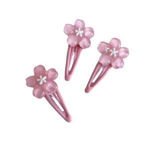 Three sweet pink cherry blossom hair clips for women and kids on a white background
