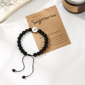 Close-up of Sagittarius zodiac bracelet with black matte beads and tiger eye stone