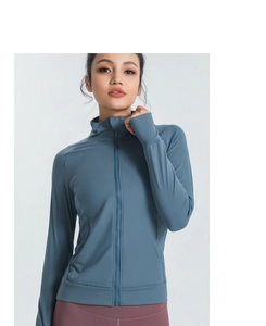 Detail of slim-fit yoga jacket showing stand collar zipper and thumbhole cuffs design