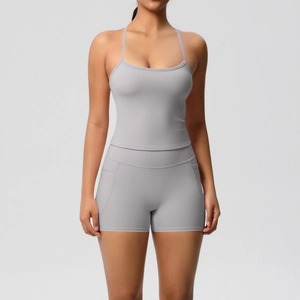 Front view of grey two-piece yoga set featuring thin strap tank top and high waist shorts