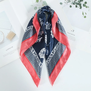 Blue satin square scarf with white floral patterns and red borders on white background