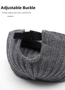 Detailed macro view of gray knitted beanie with adjustable elastic strap and plastic buckle