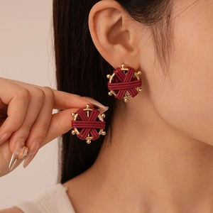 Retro burgundy woven faux leather round earrings with golden metal frame for women