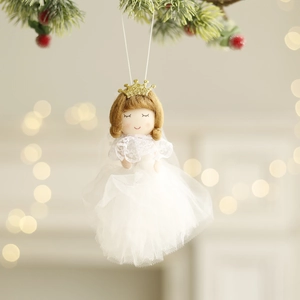 White Christmas angel doll ornament with golden crown hanging on a festive pine branch