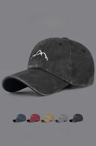 Detail view of vintage washed cotton baseball caps with embroidered mountain pattern