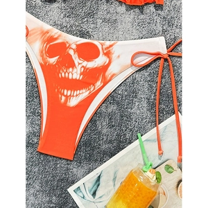 Orange and white bikini bottom with skull print and adjustable side ties for beachwear
