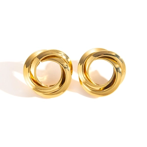 Macro shot of gold spiral stud earrings featuring a polished triple-loop geometric design