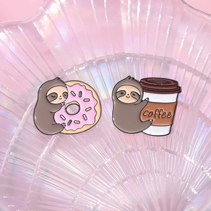 Cute cartoon sloth enamel pin set featuring coffee and pink donut on a shell plate