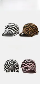 Close-up of zebra pattern baseball caps with adjustable metal buckles in multiple colors