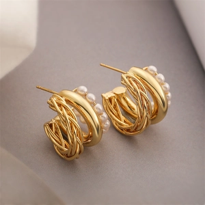 Minimalist gold-plated C-shape hoop earrings with woven metal and pearl accents