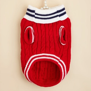 Detailed close-up of a red cable knit dog sweater with striped ribbed hem and collar