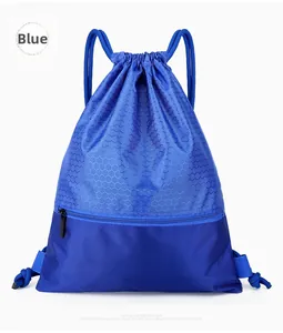 Detail of the blue nylon drawstring bag showing the honeycomb pattern and front zipper pocket