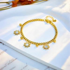 Elegant gold titanium sunflower chain bracelet with white shell inlays on stone tray